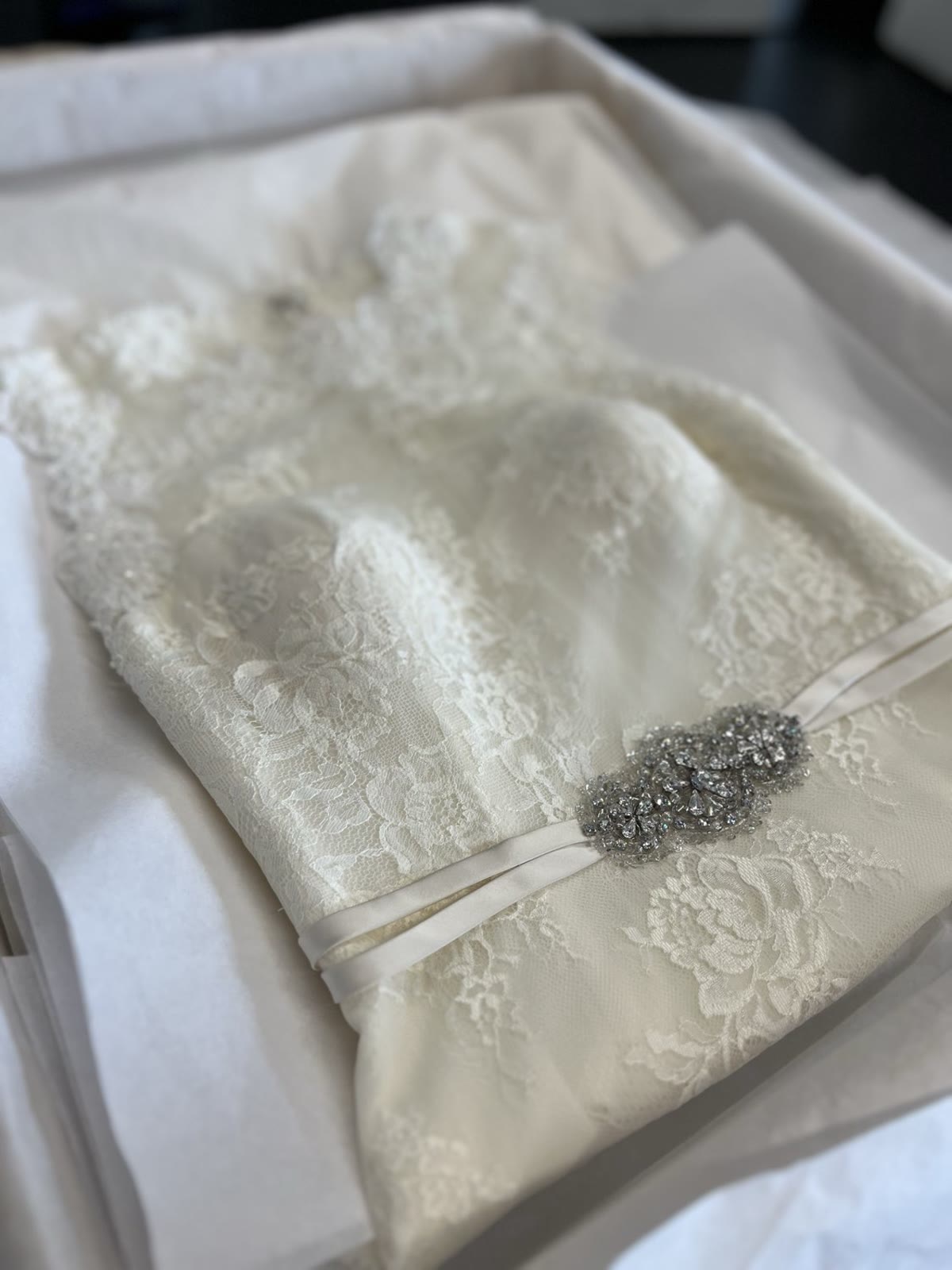 Lace wedding gown preserved in an acid-free box